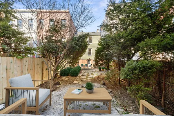 a view of a patio with table and chairs and potted plants