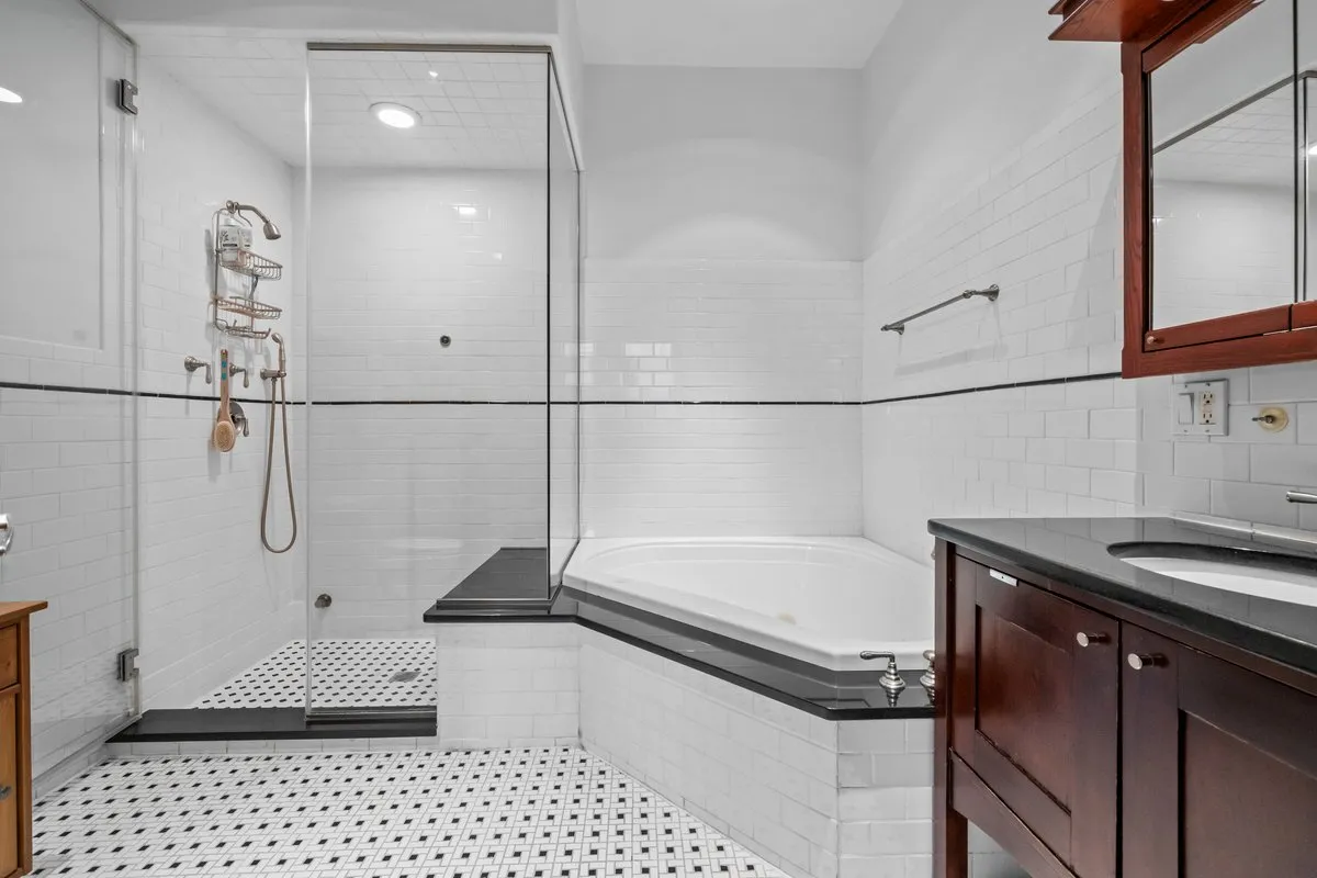 a bathroom with a bathtub and a shower