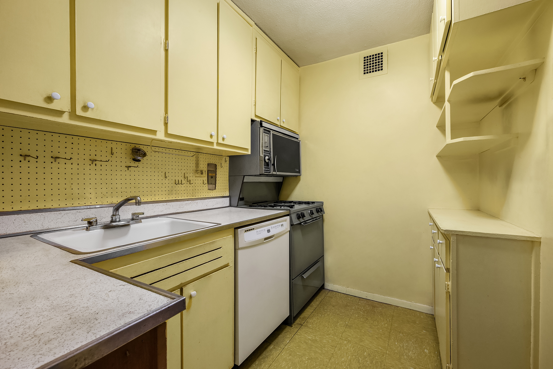 75 Henry Street, Unit 9G Brooklyn, NY 11201 - Photo 5 of 13 a kitchen with a sink a stove and cabinets
