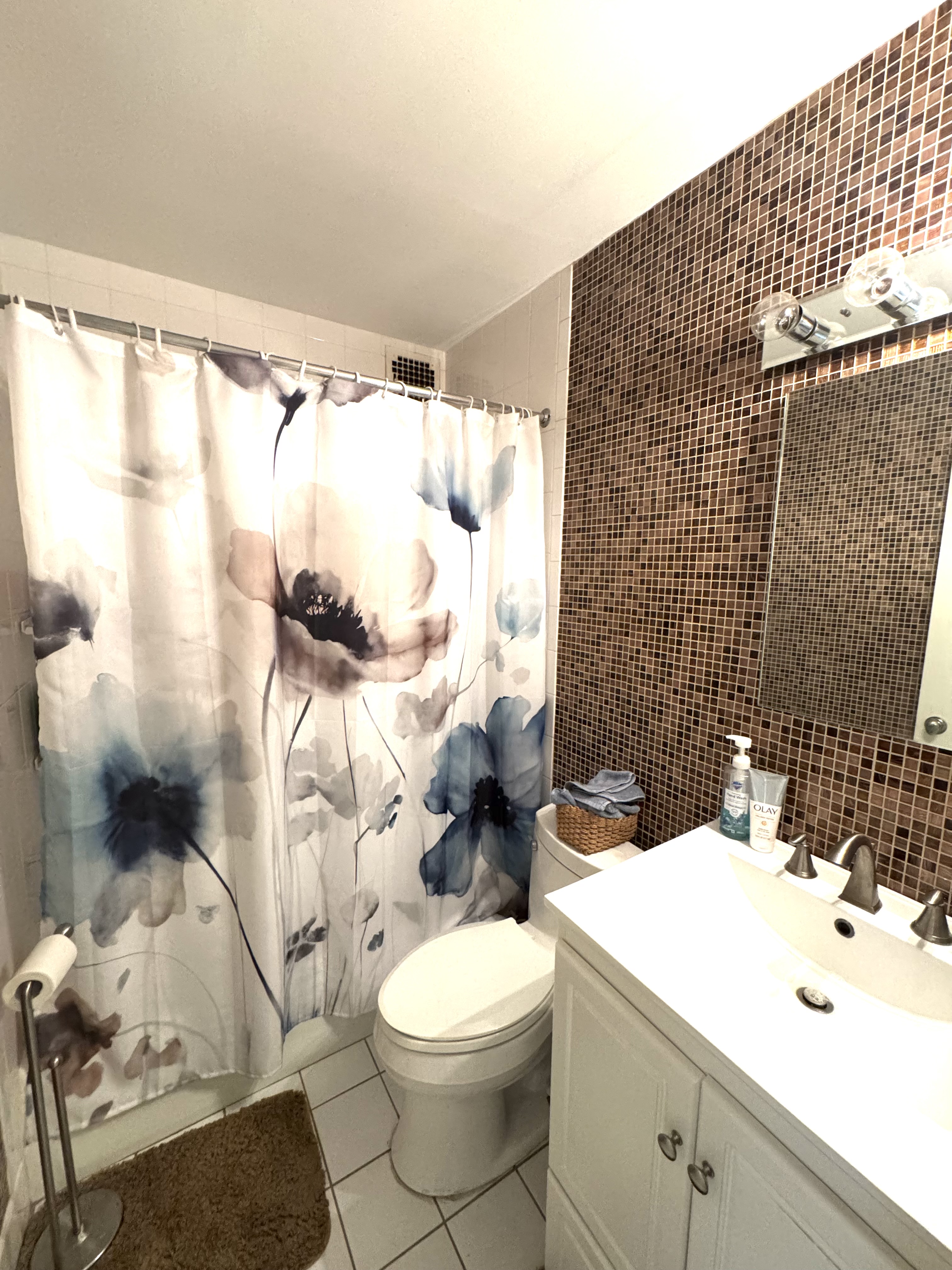 61 East 77th Street, Unit 7E Manhattan, NY 10075 - Photo 4 of 10 a bathroom with a sink toilet and shower