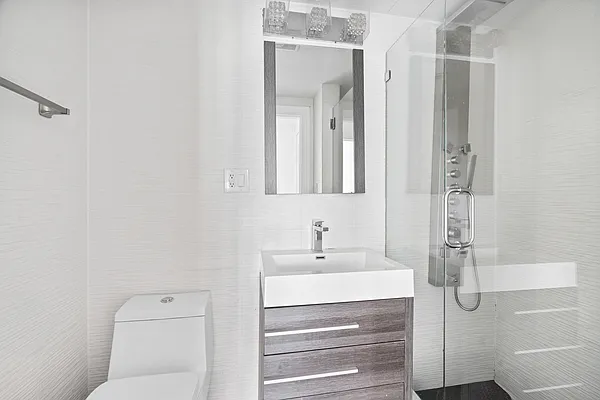 20 Avenue A, Unit 3AB Manhattan, NY 10009 - Photo 12 of 13 a bathroom with a shower a sink and a mirror
