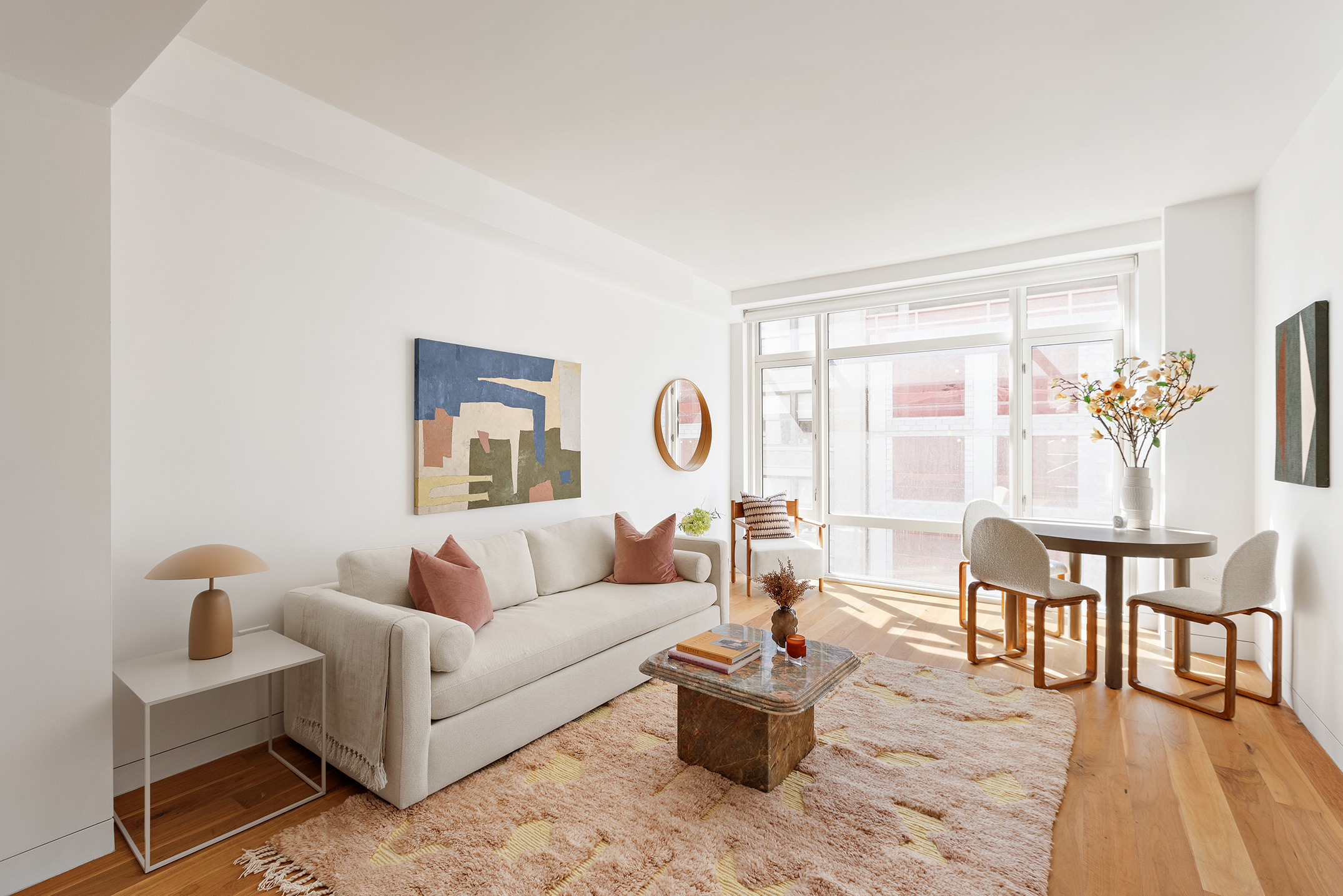 151 West 21st Street, Unit 9C Manhattan, NY 10011 - Photo 2 of 10 a living room with furniture and a table