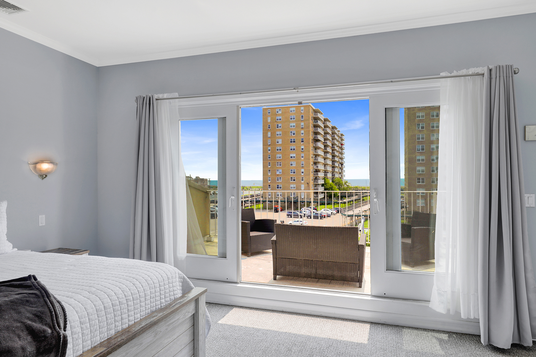102-20 Rockaway Beach Boulevard, Unit 3C Queens, NY 11694 - Photo 23 of 36 a bedroom with a bed and a large window