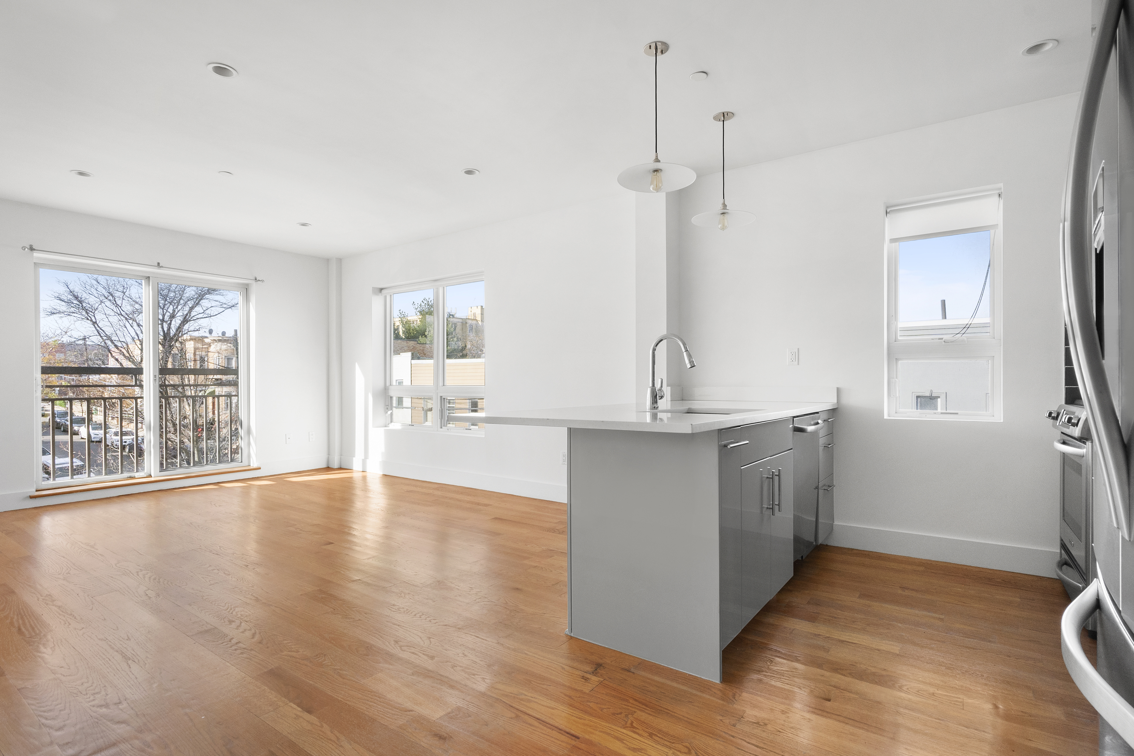 63-34 Fresh Pond Road, Unit 3D Queens, NY 11385 - Photo 3 of 14 a view of a kitchen with a sink and dishwasher kitchen view with wooden floor