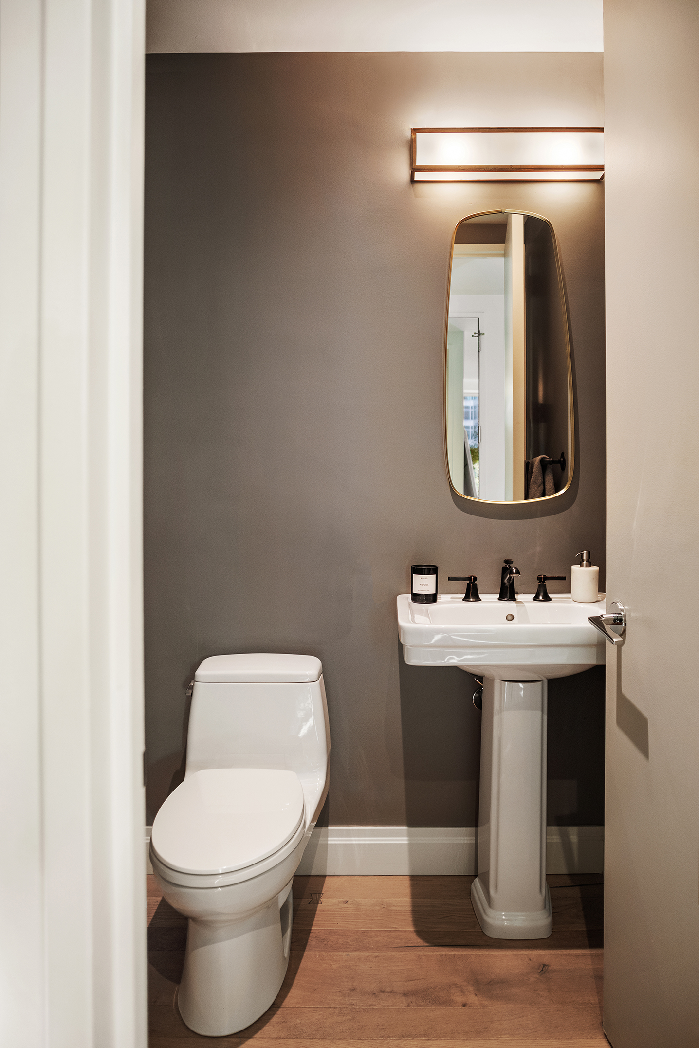 101 Warren Street, Unit 2010 Manhattan, NY 10007 - Photo 10 of 18 a bathroom with a toilet a sink and mirror