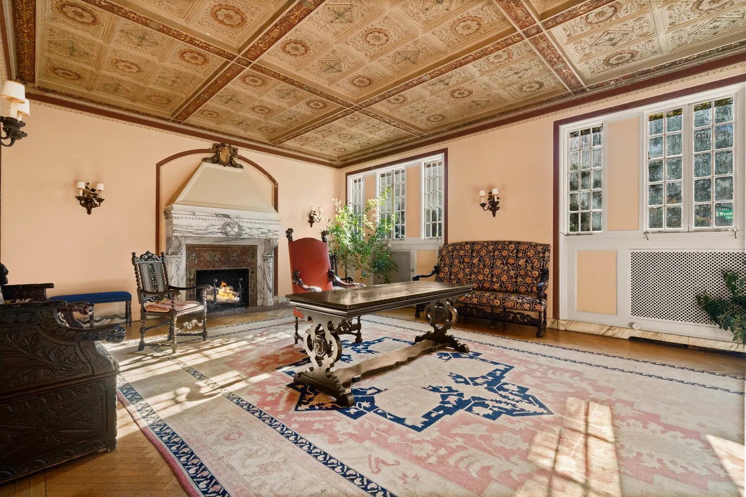 a living room with furniture a fireplace and potted plants