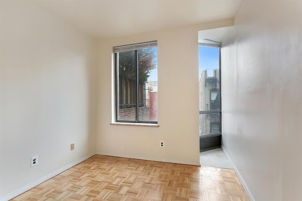 229 East 24th Street, Unit 9R Manhattan, NY 10010 - Photo 3 of 5 a view of an empty room with window and closet area