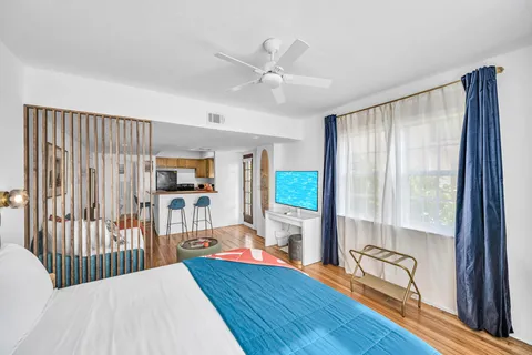 a bedroom with furniture wooden floor and windows
