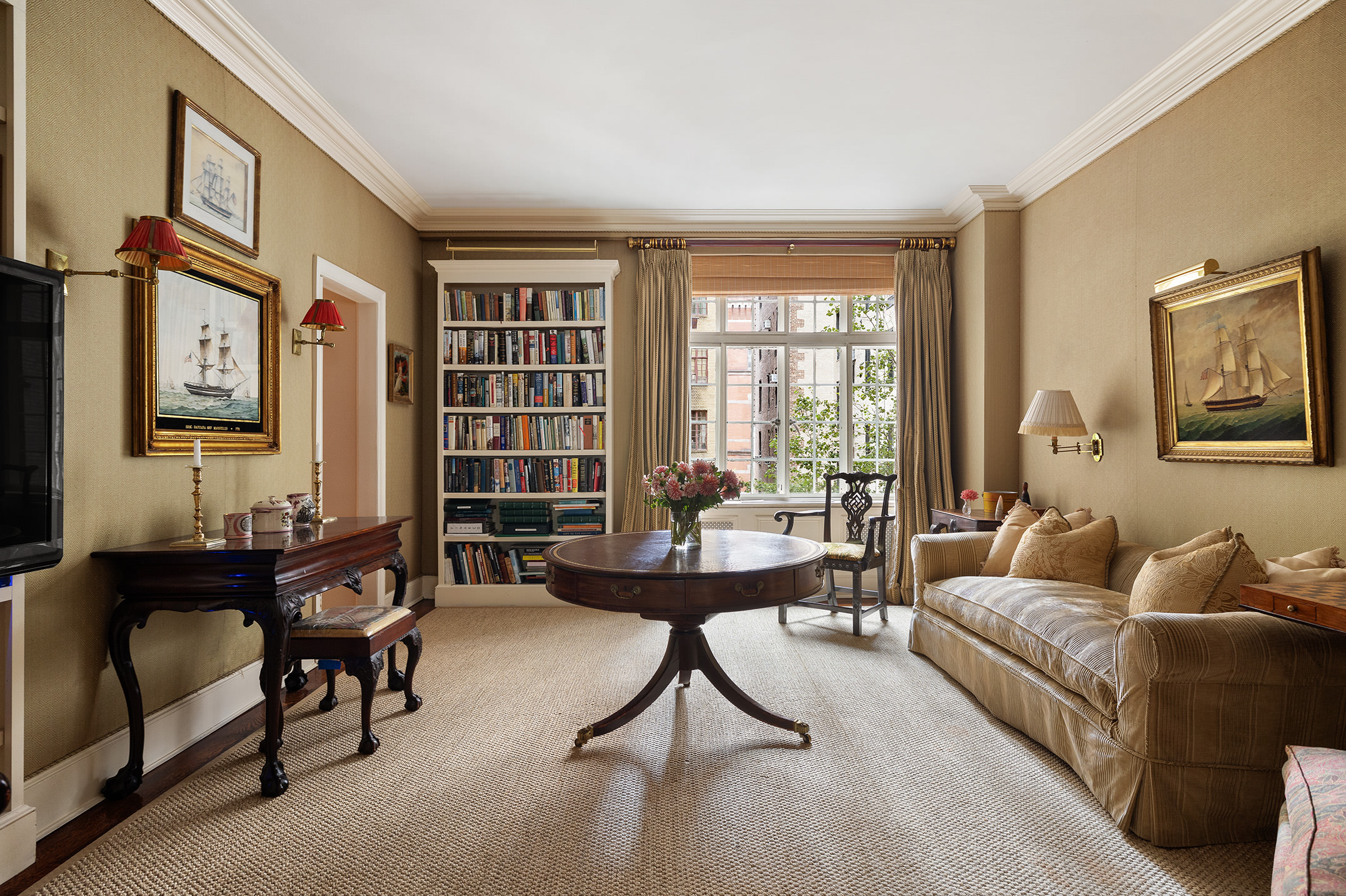 116 East 68th Street, Unit 2D Manhattan, NY 10065 - Photo 4 of 12 a living room with furniture and a large window