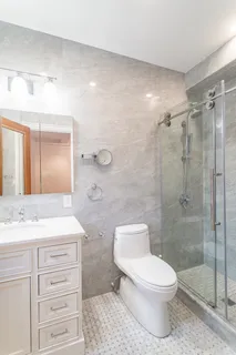 a bathroom with a toilet a sink and shower