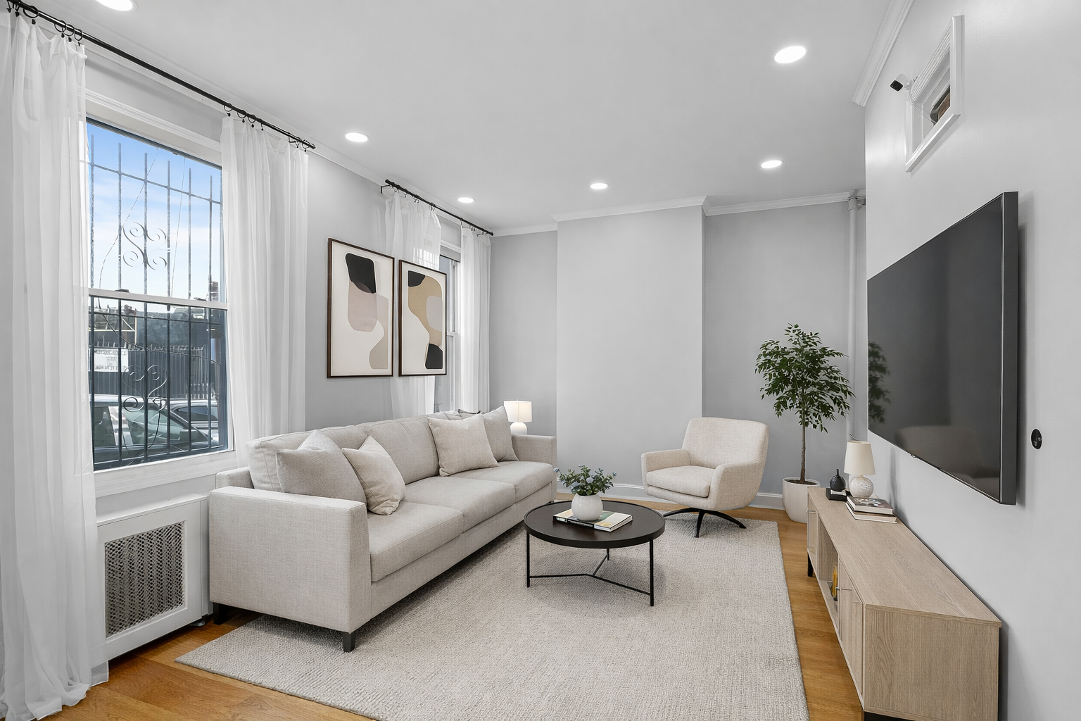 131 20th Street, Unit MULTI Brooklyn, NY 11232 - Photo 5 of 16 a living room with furniture a flat screen tv and a large window