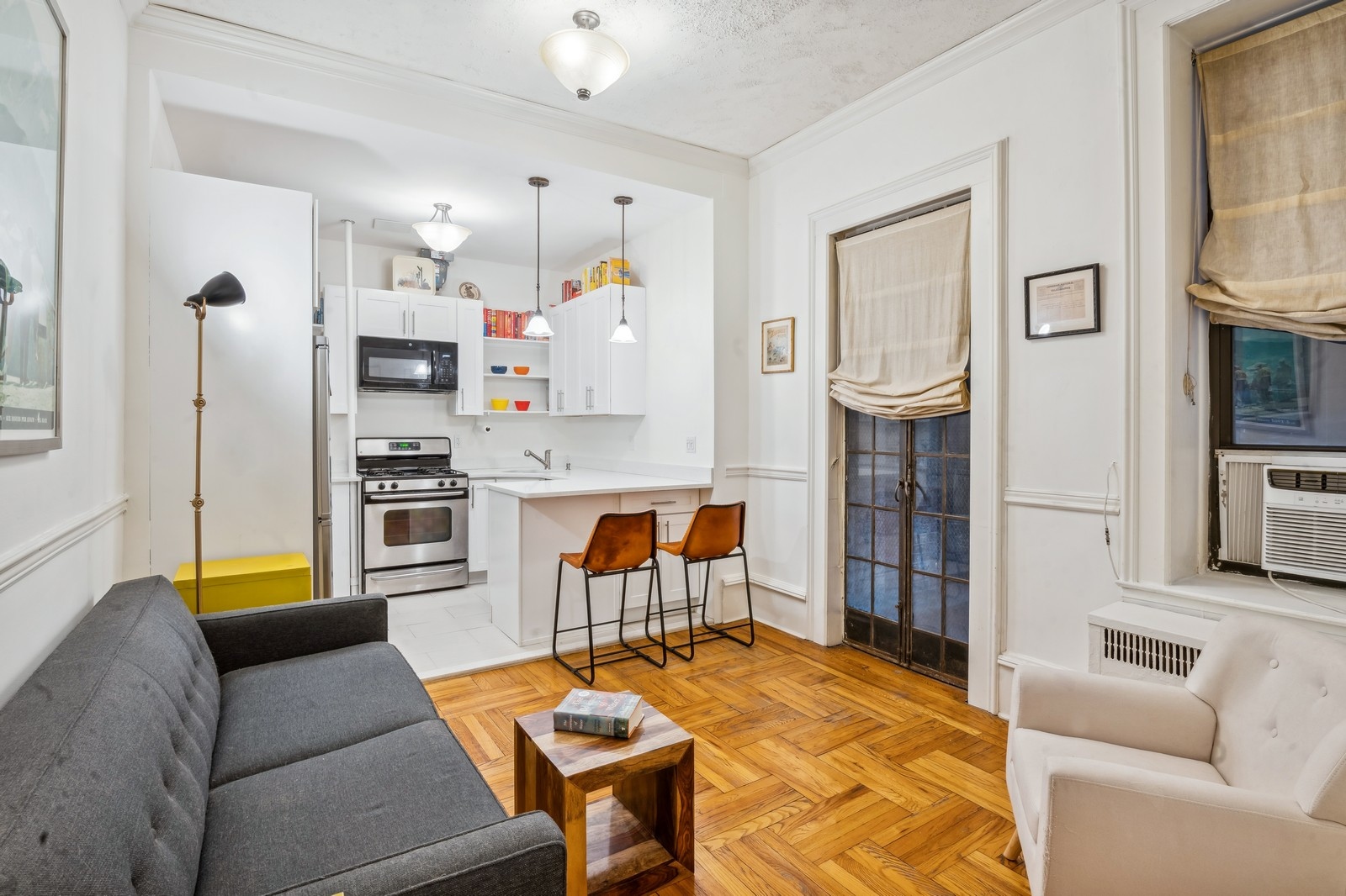 401 West End Avenue, Unit 1G Manhattan, NY 10024 - Photo 3 of 9 a living room with furniture and a kitchen view