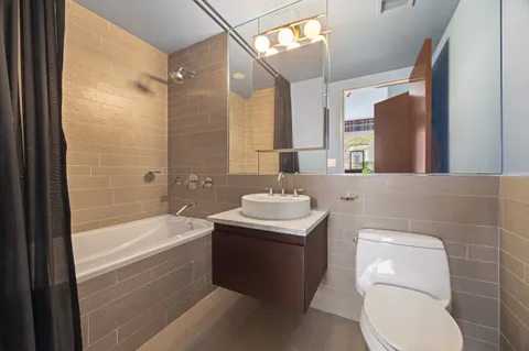 a bathroom with a sink a toilet and bathtub