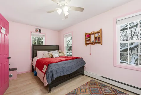 a bedroom with a bed and a painting on the wall