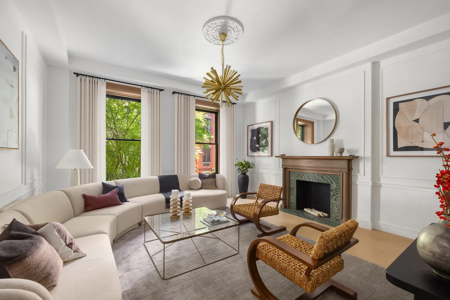 a living room with furniture a fireplace and a large window