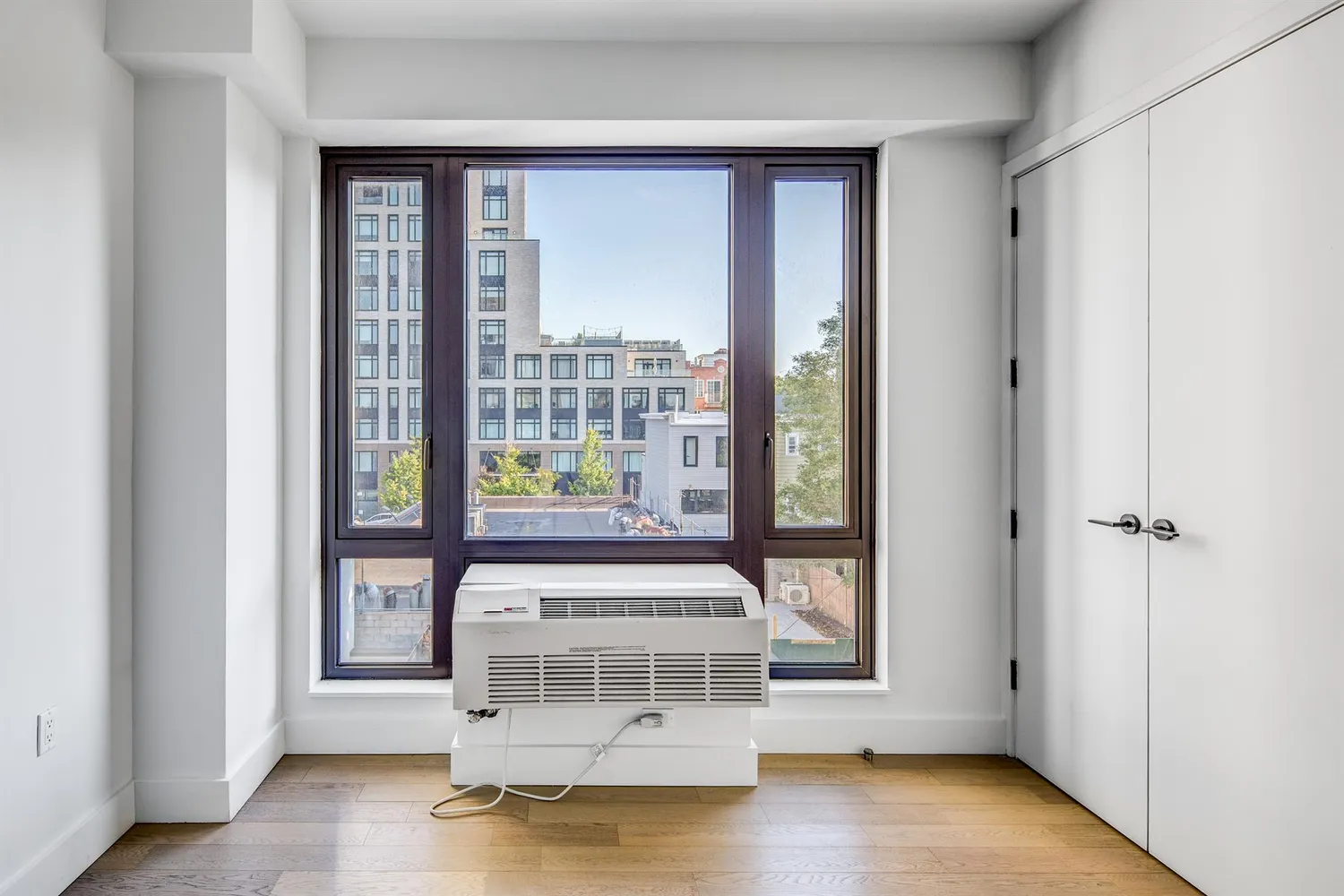 a view of a entryway with wooden floor and windows