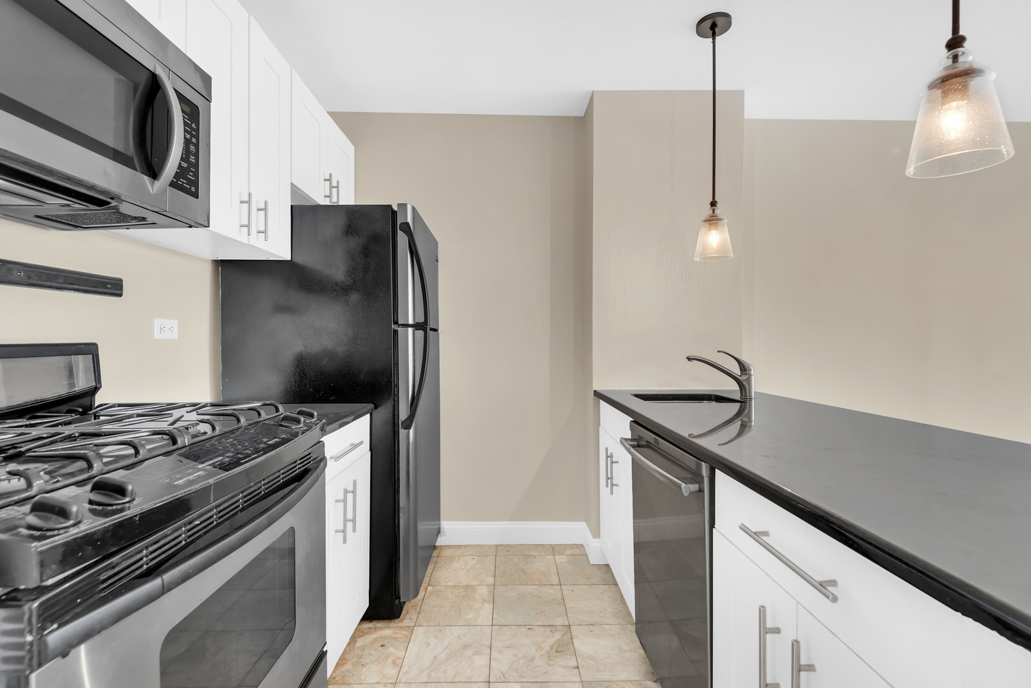 270 West 17th Street, Unit 8B Manhattan, NY 10011 - Photo 2 of 6 a kitchen with stainless steel appliances granite countertop a sink stove and refrigerator