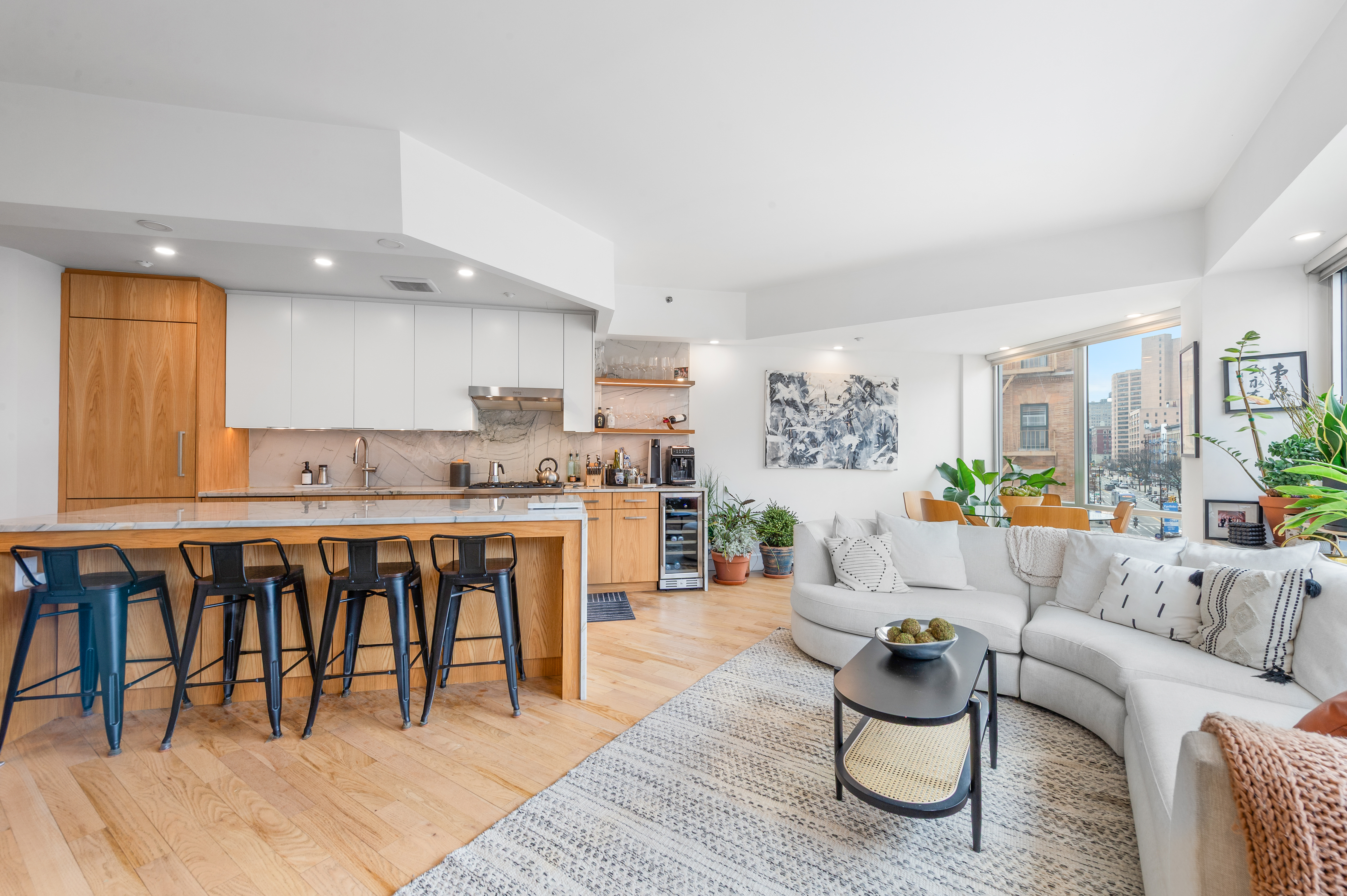 2110 Frederick Douglass Boulevard, Unit 4C Manhattan, NY 10026 - Photo 2 of 19 a living room with stainless steel appliances granite countertop a couch and a wooden floor