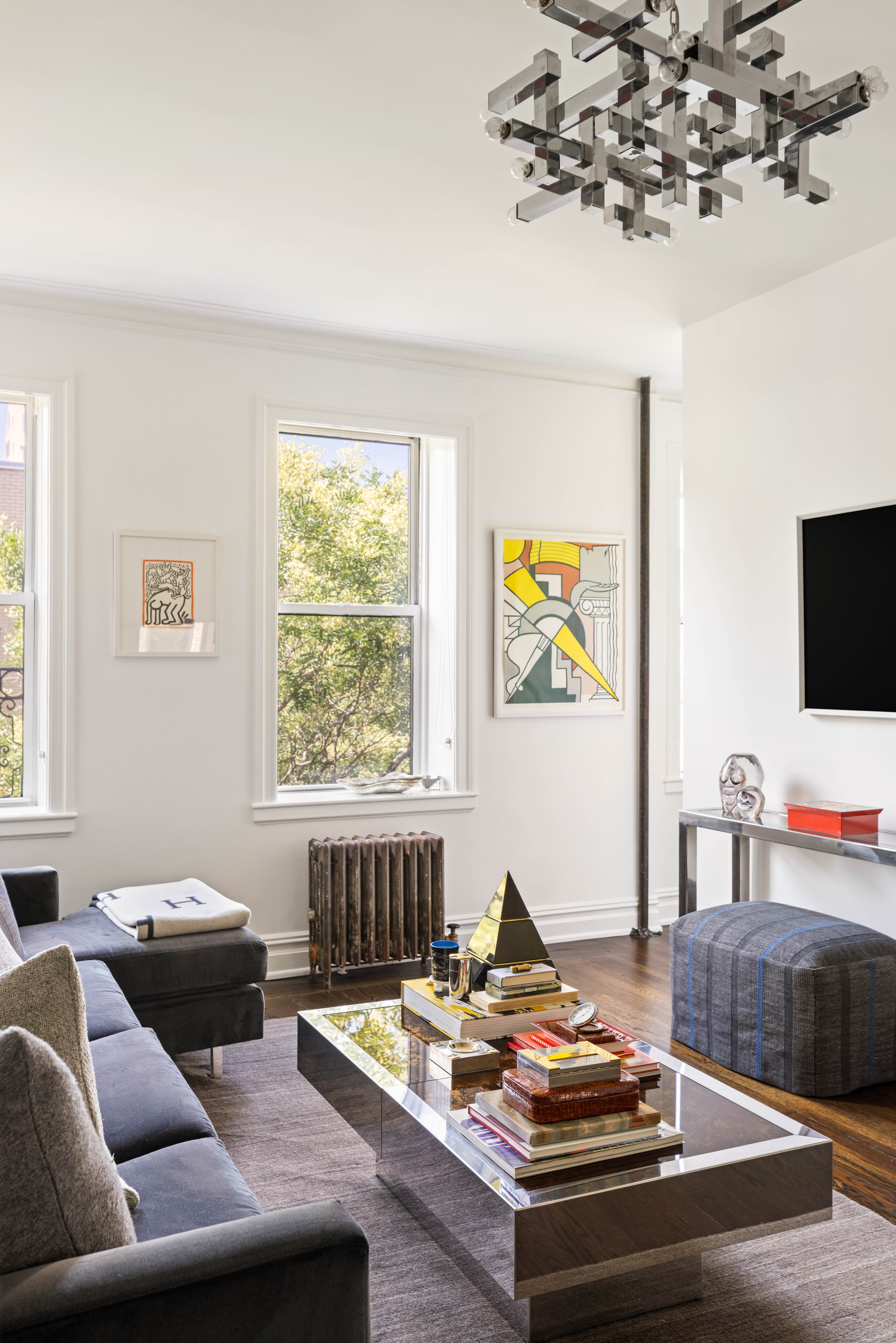 253 West 16th Street, Unit 5C Manhattan, NY 10011 - Photo 10 of 11 a living room with furniture and a flat screen tv