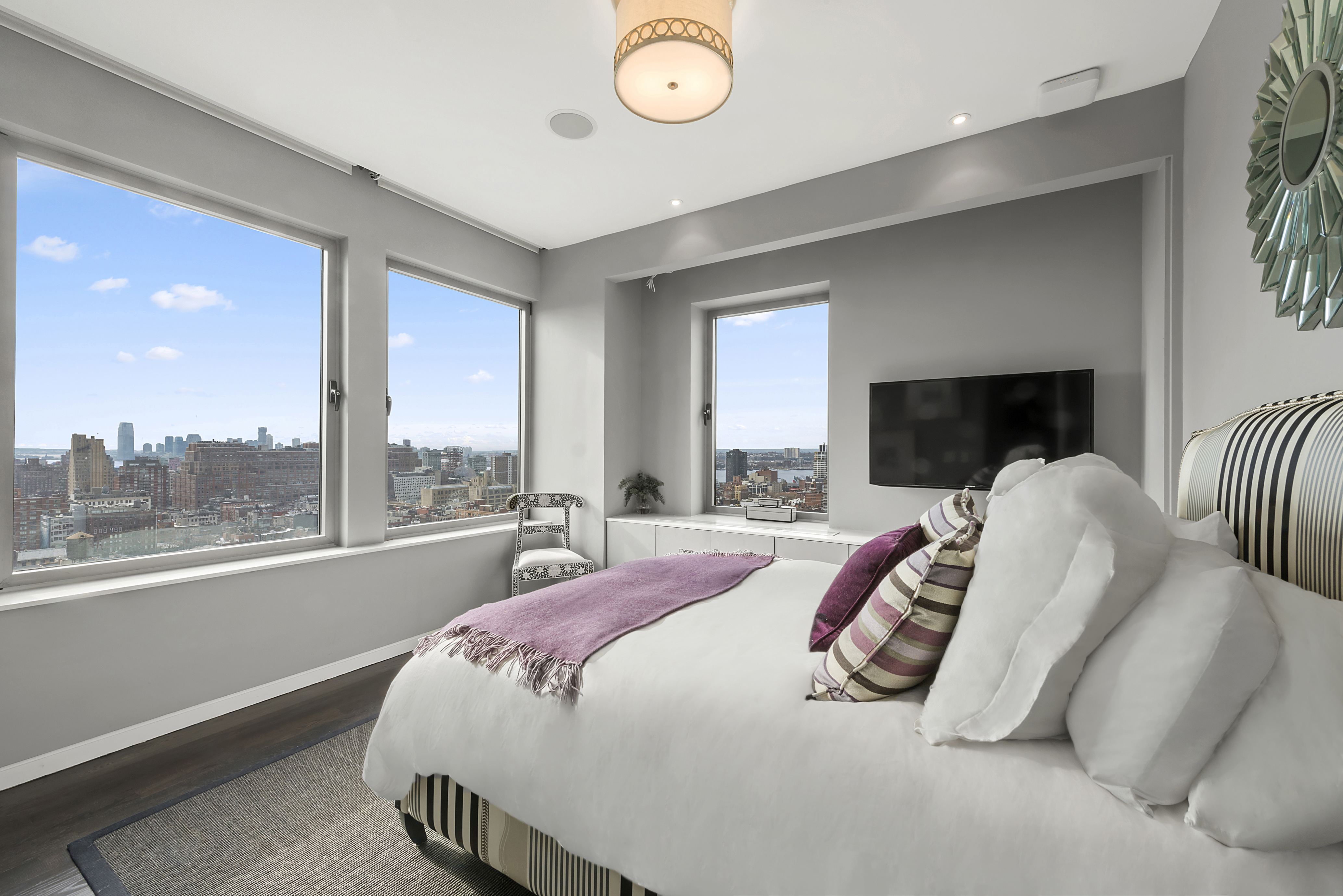 252 7th Avenue, Unit PHD Manhattan, NY 10001 - Photo 14 of 26 a bed sitting in a bedroom next to a window