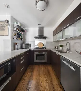 a kitchen with stainless steel appliances granite countertop a stove a sink dishwasher and a refrigerator