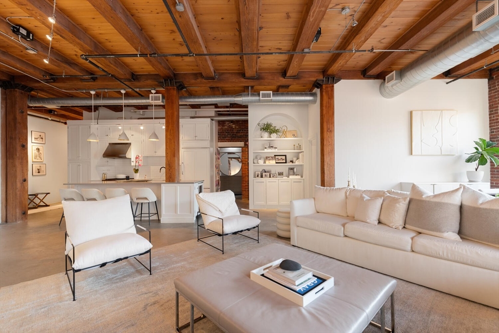 35 Channel Center Street, Unit 402 Boston, MA 02210 - Photo 16 of 35 a living room with furniture and a chandelier