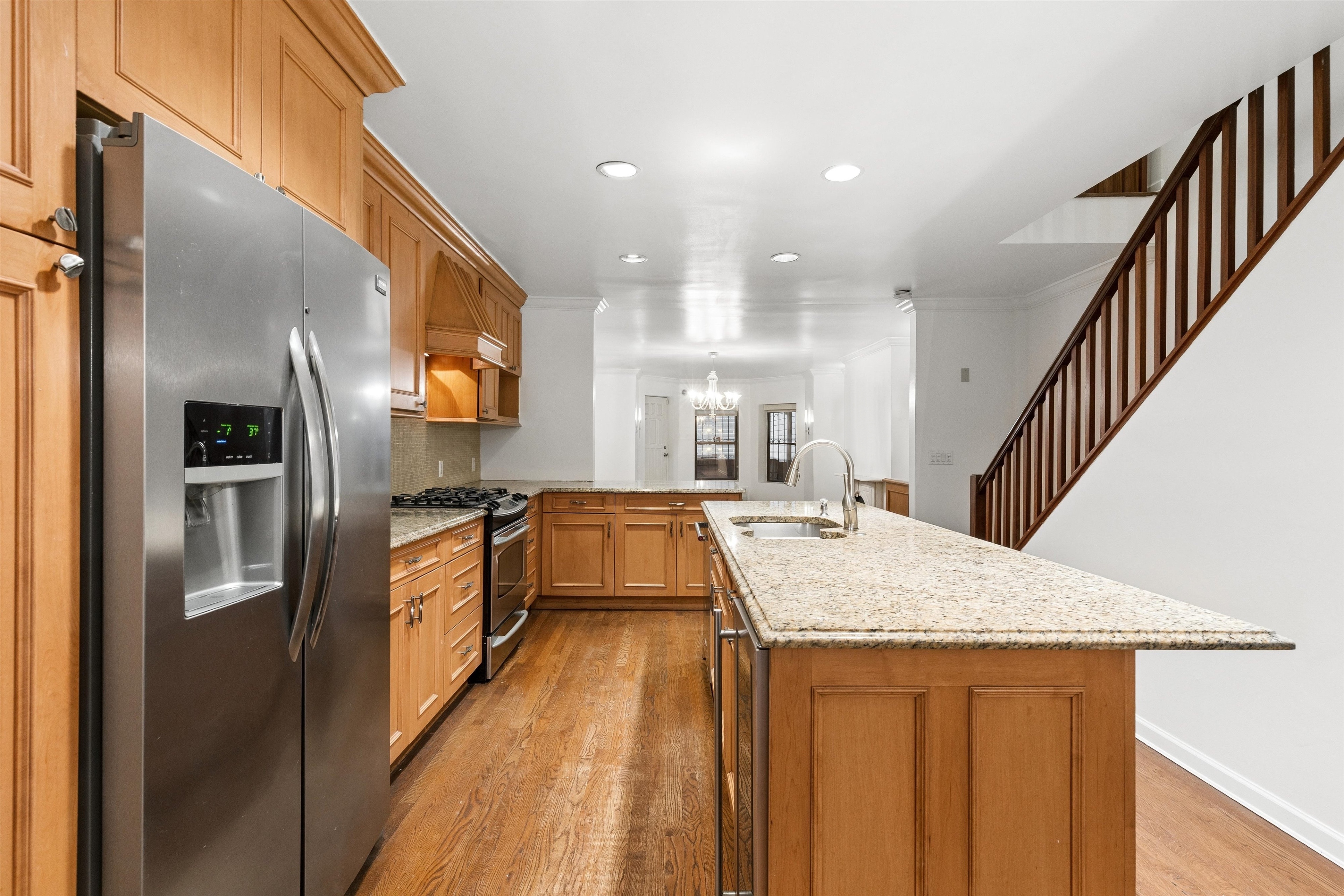 165 West 126th Street Manhattan, NY 10027 - Photo 6 of 40 a kitchen with kitchen island granite countertop lots of counter top space and stainless steel appliances
