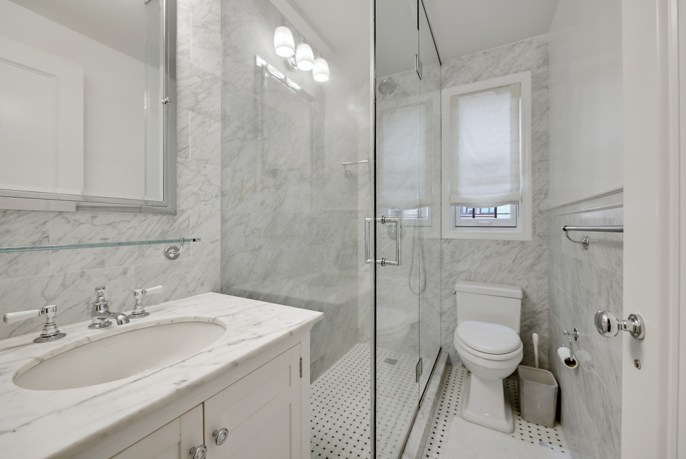 7 East 85th Street, Unit 5AB Manhattan, NY 10028 - Photo 10 of 12 a bathroom with a sink toilet and shower