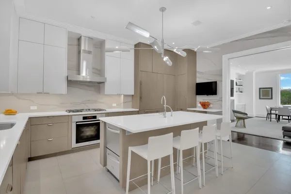 a kitchen with a stove a sink a dining table and chairs