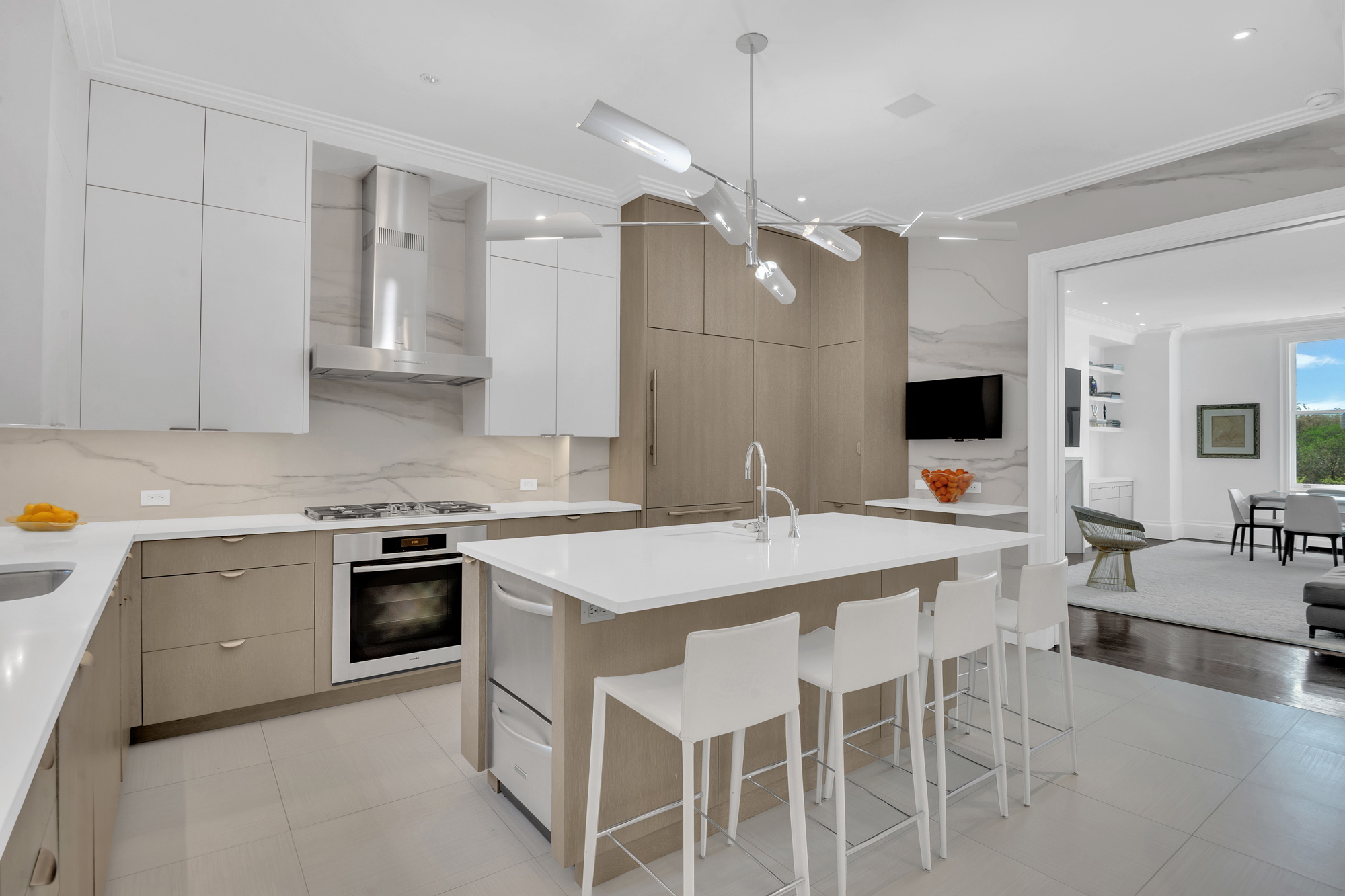 988 5th Avenue Manhattan, NY 10075 - Photo 3 of 14 a kitchen with a stove a sink a dining table and chairs