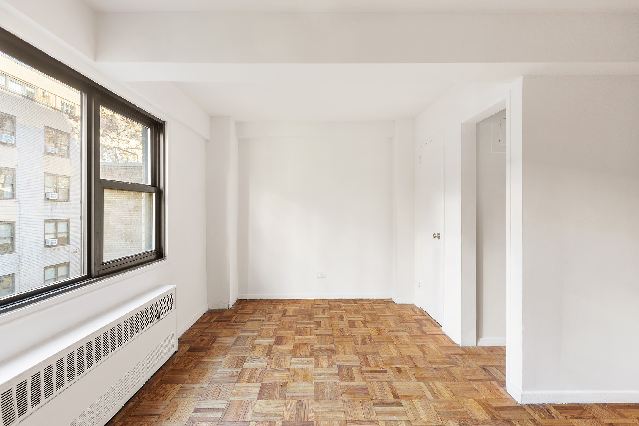 335 East 51st Street, Unit 6G Manhattan, NY 10022 - Photo 6 of 12 a view of an empty room and window