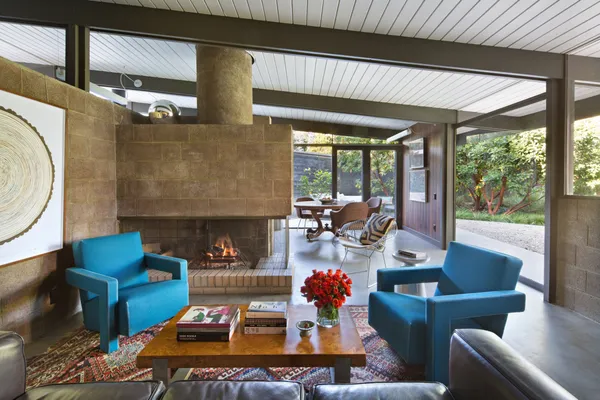 a living room with furniture a fireplace and a table