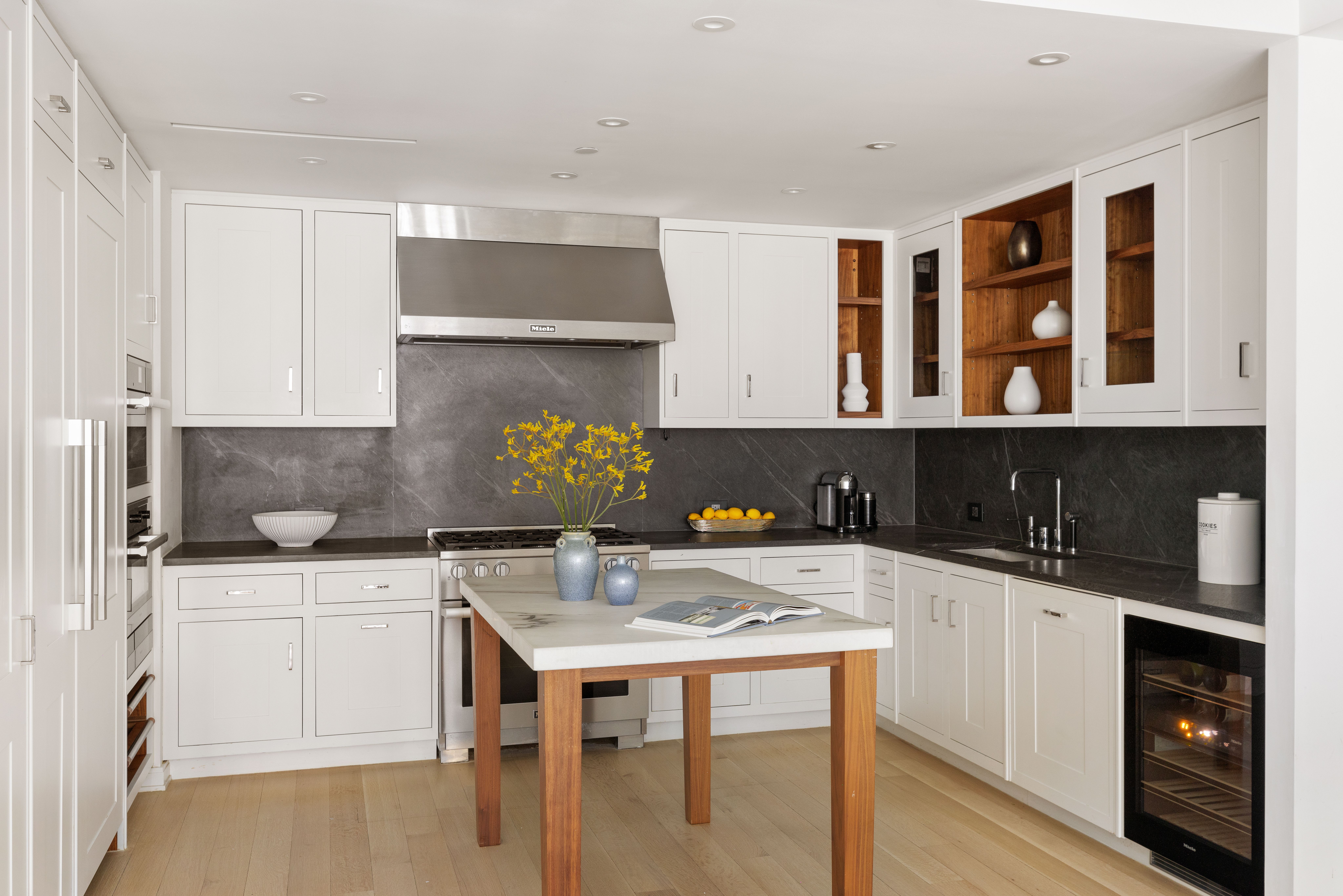 221 West 77th Street, Unit 4E Manhattan, NY 10024 - Photo 4 of 20 a kitchen with a sink a stove and cabinets