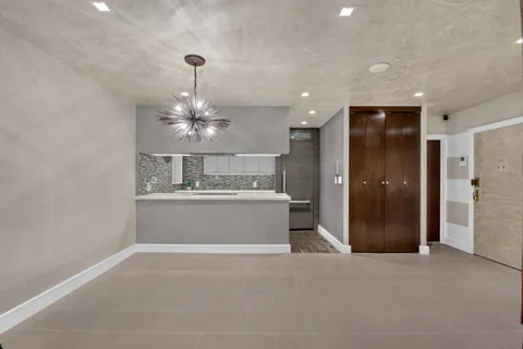 a view of a hallway with a chandelier