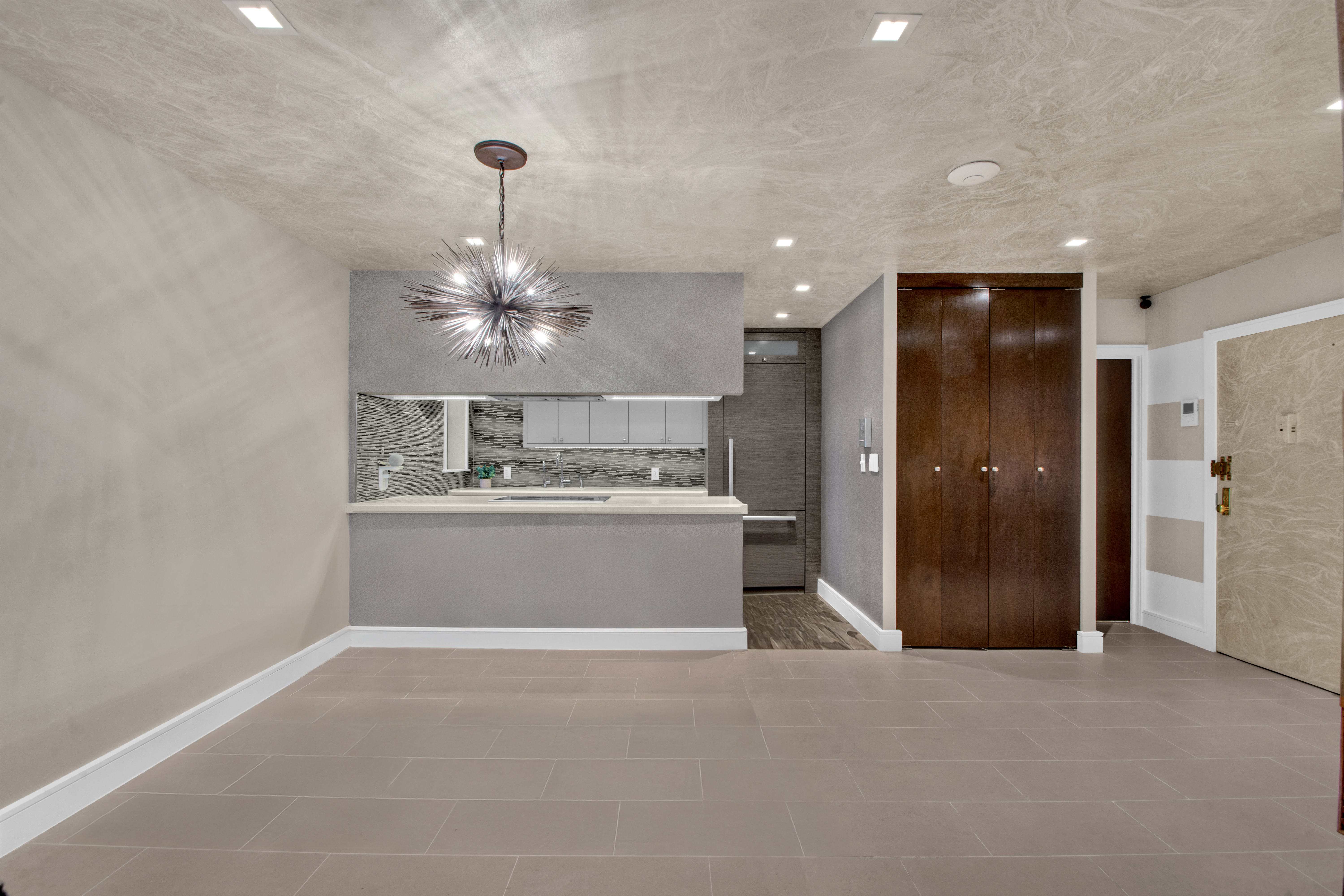690 Washington Street, Unit 1A Manhattan, NY 10014 - Photo 5 of 17 a view of a hallway with a chandelier