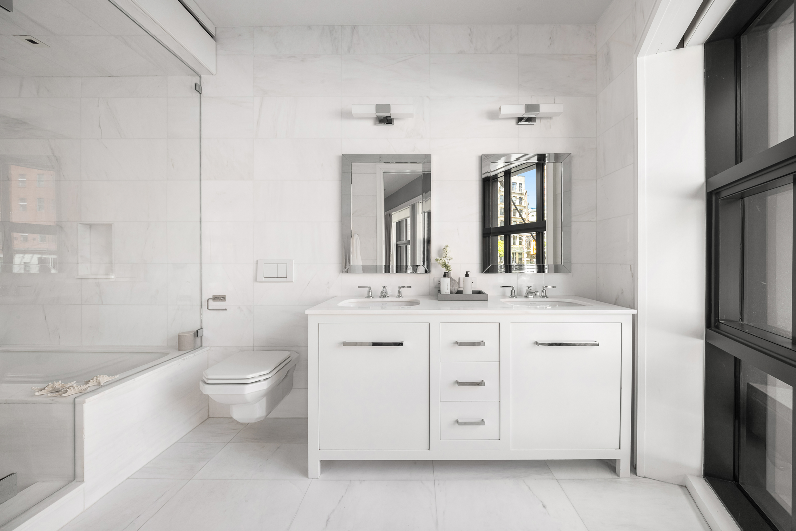 137 Franklin Street, Unit 1 Manhattan, NY 10013 - Photo 12 of 25 a bathroom with a granite countertop toilet sink and mirror