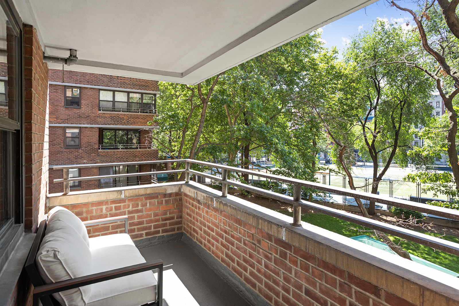 385 Grand Street, Unit L207 Manhattan, NY 10002 - Photo 9 of 12 a view of balcony with two chairs and a table
