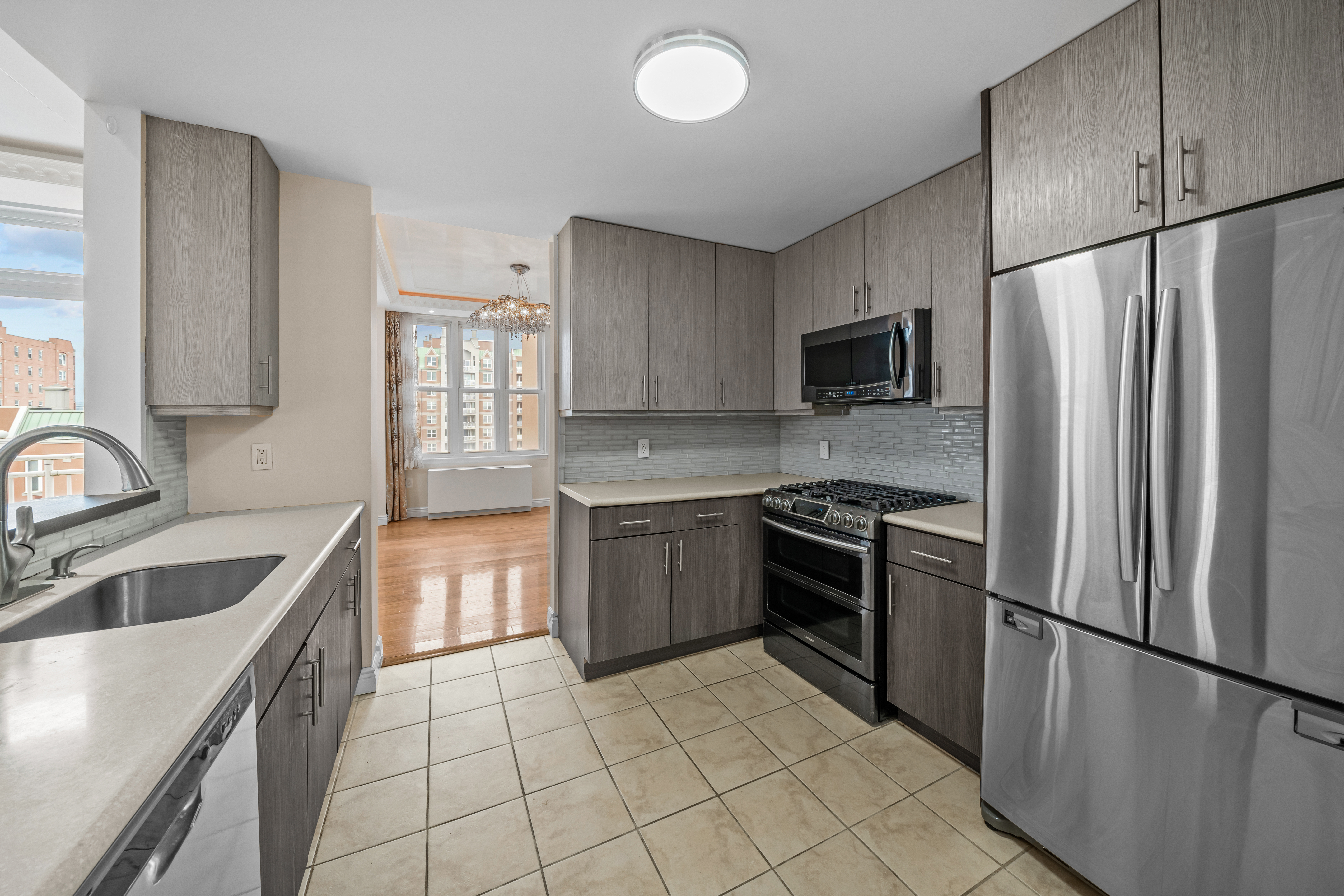 105 Oceana Drive East, Unit PH1D Brooklyn, NY 11235 - Photo 6 of 27 a kitchen with granite countertop a refrigerator and a sink