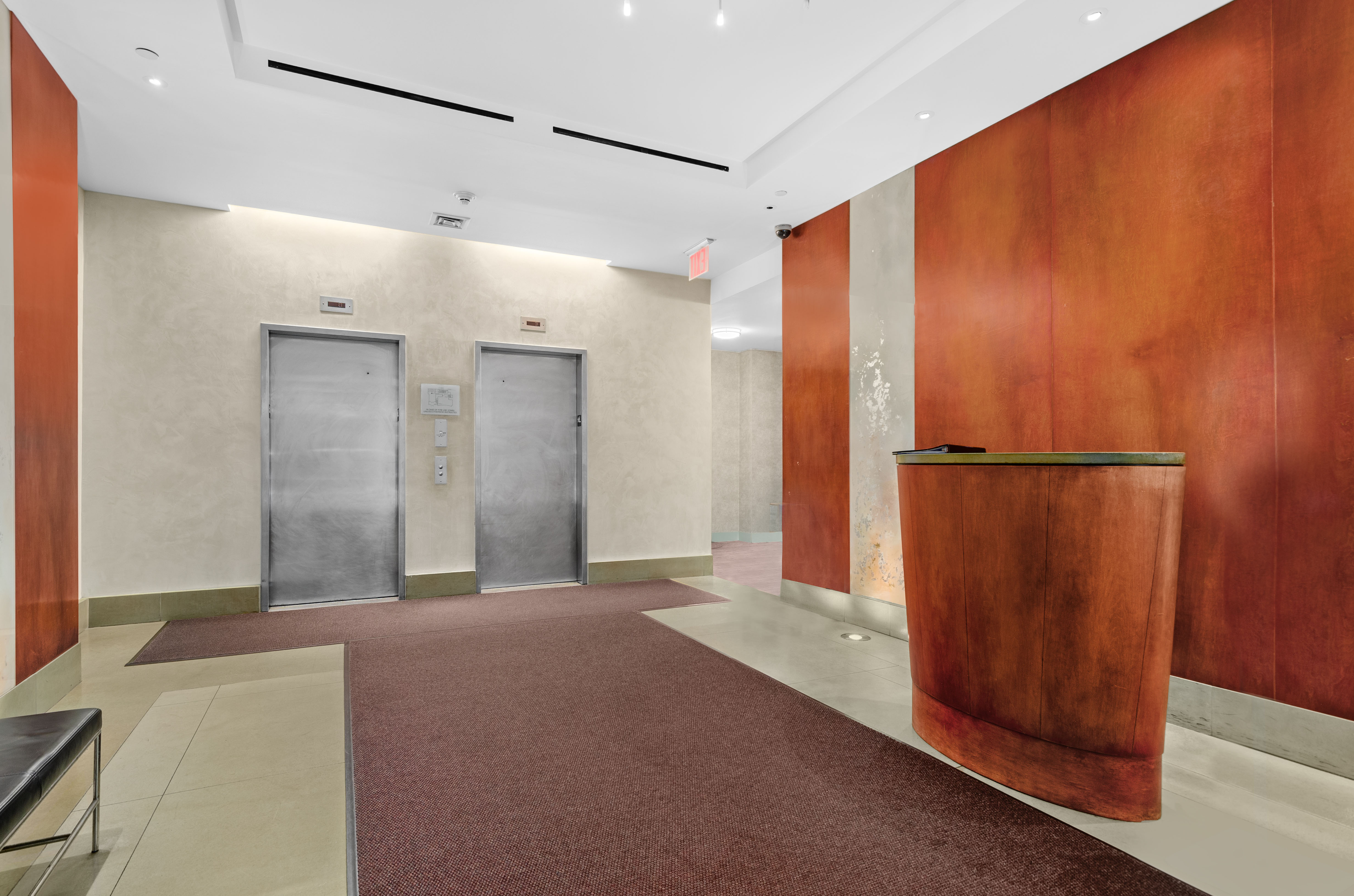 242 East 25th Street, Unit 5B Manhattan, NY 10010 - Photo 11 of 12 a view of a hallway with wooden walls