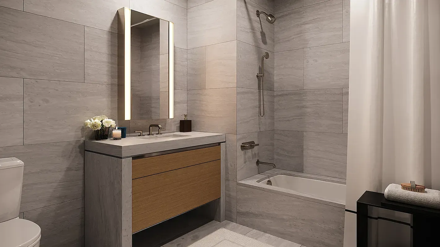a bathroom with a granite countertop sink toilet and shower