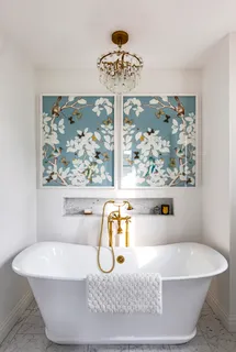 a white bath tub sitting next to a window