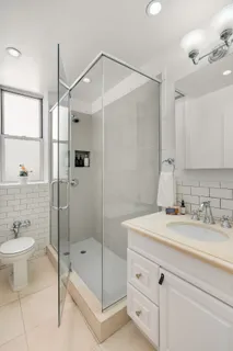 a bathroom with a shower sink and mirror