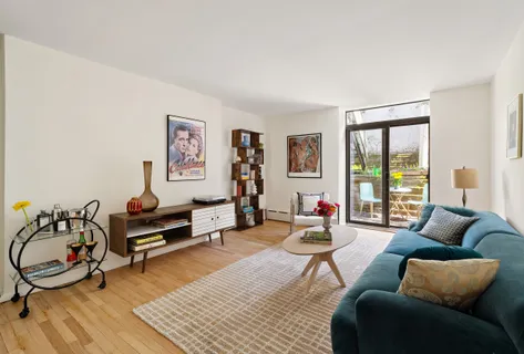 a living room with furniture a rug and a large window