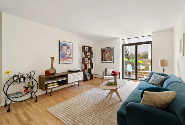a living room with furniture a rug and a large window