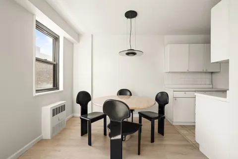 a view of a dining room with furniture and windows