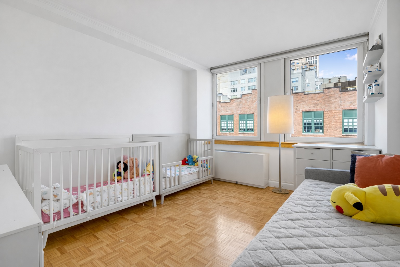 404 East 76th Street, Unit 6K Manhattan, NY 10021 - Photo 5 of 12 a bed room with a bed and a window