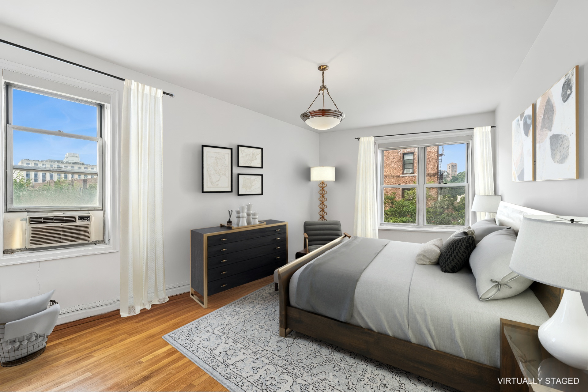 91 Payson Avenue, Unit 4D Manhattan, NY 10034 - Photo 9 of 24 a bedroom with a bed and wooden floor