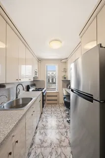 a kitchen with sink cabinets and refrigerator