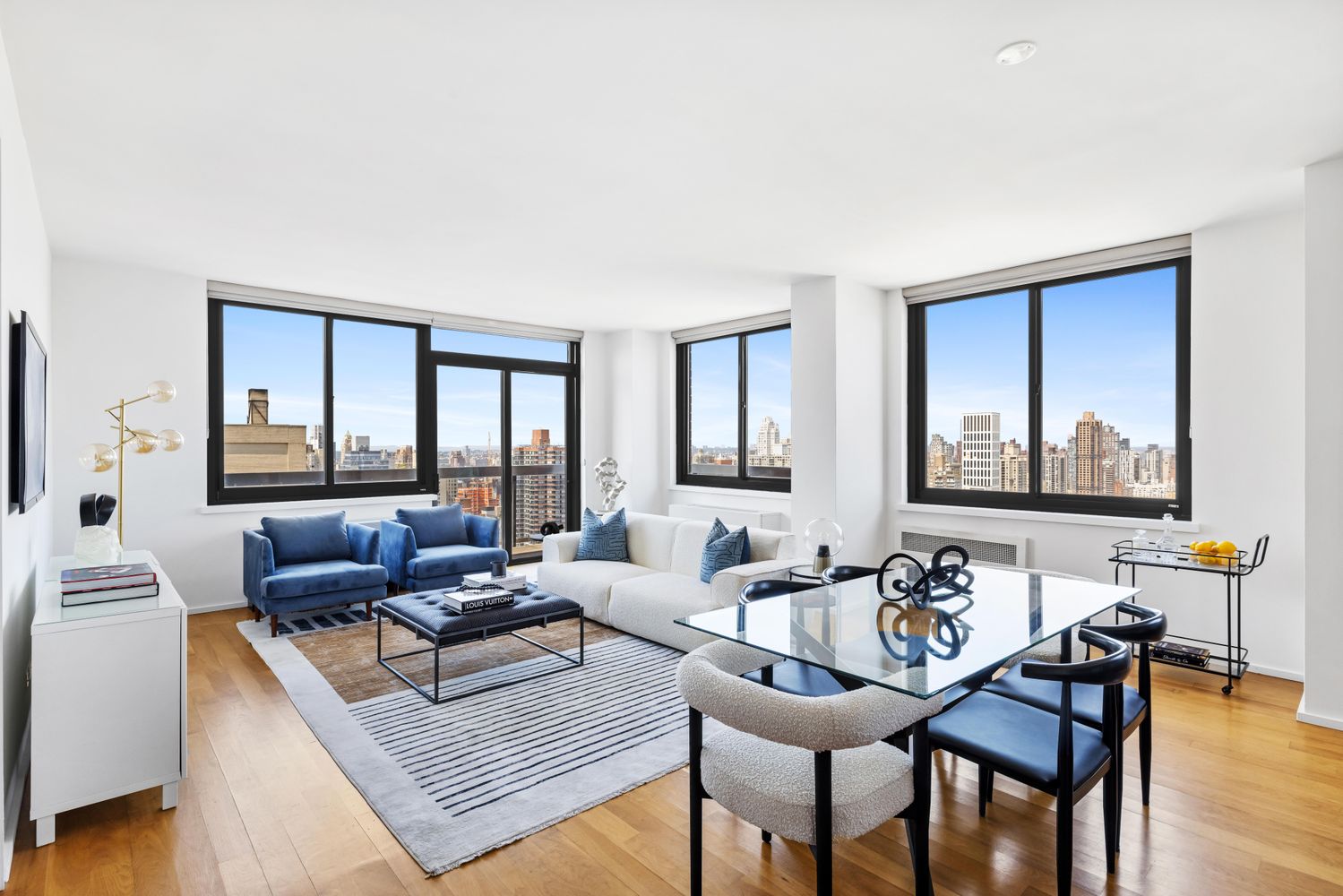 a living room with furniture and large windows
