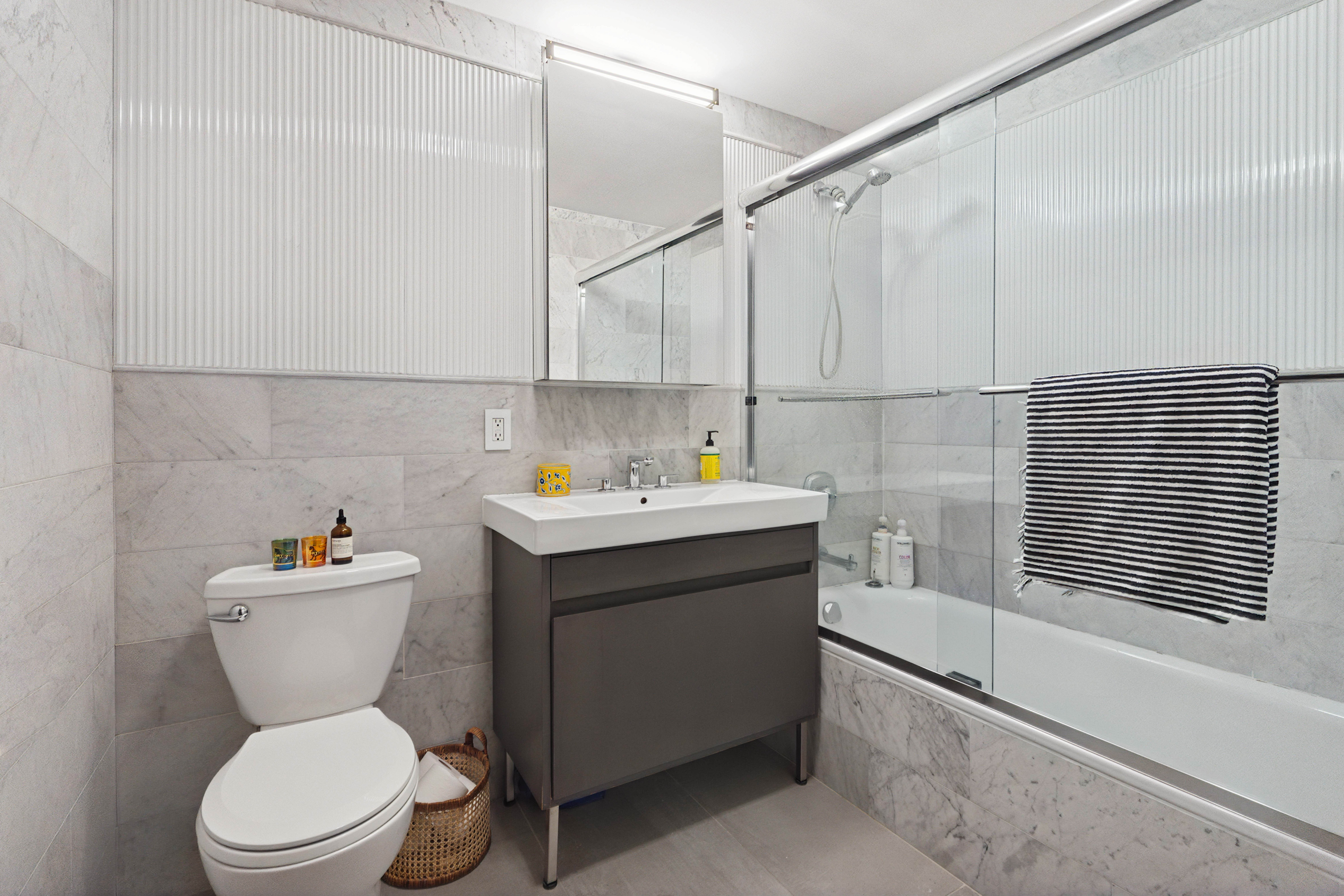 25 Monroe Place, Unit 2A Brooklyn, NY 11201 - Photo 5 of 14 a bathroom with a sink a toilet and shower